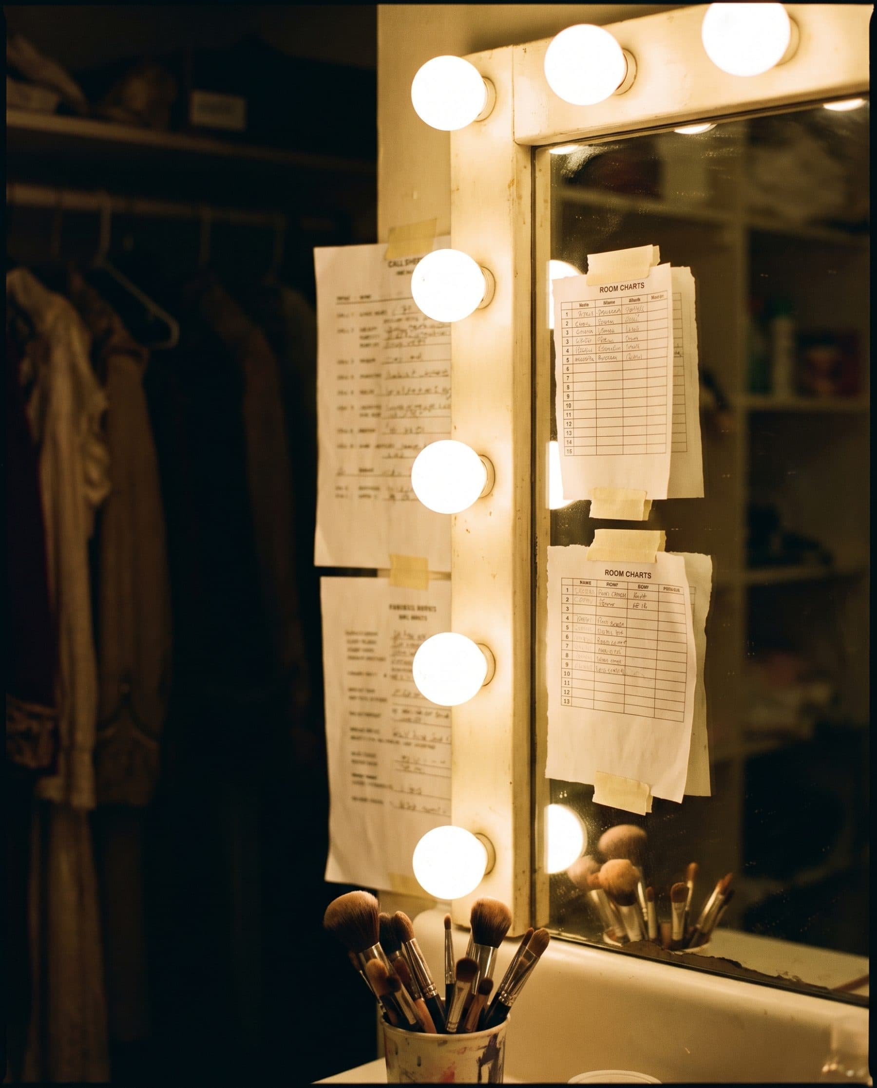 Dressing room mirror with room charts taped to it